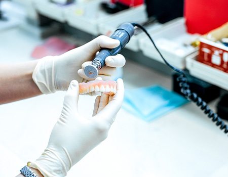 A dental technician crafting dentures