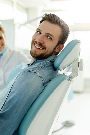 Happy dental patient looking to the side