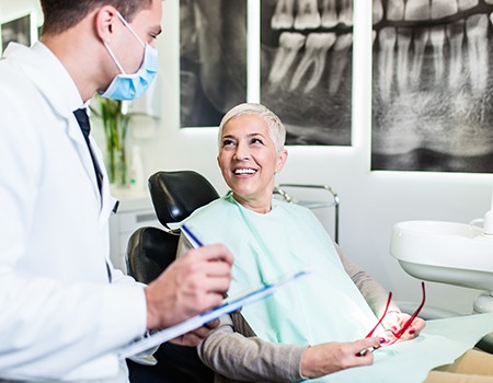 Dentist taking notes during consultation