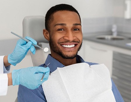 a dental patient smiling during a dental checkup